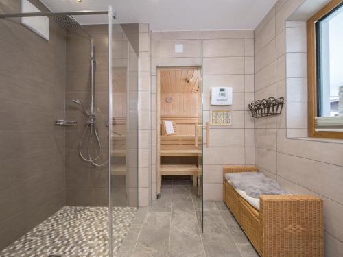 a bathroom with a shower with a glass door at Chalet deluxe with 3 bathrooms, near practice lift in Neukirchen am Großvenediger