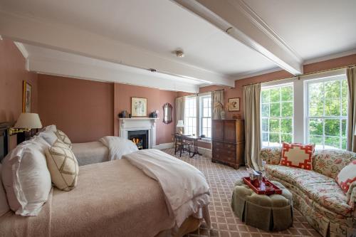 a bedroom with a bed and a couch and a fireplace at The Willcox in Aiken