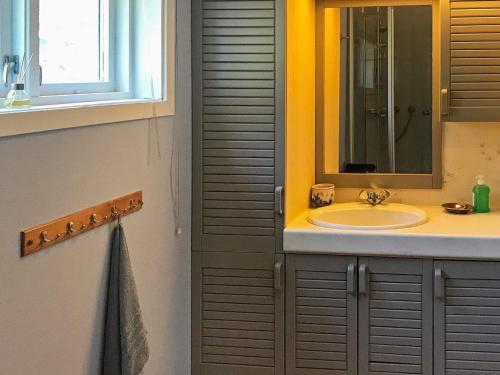 a bathroom with a sink and a mirror at 6 person holiday home in øystese in Øystese
