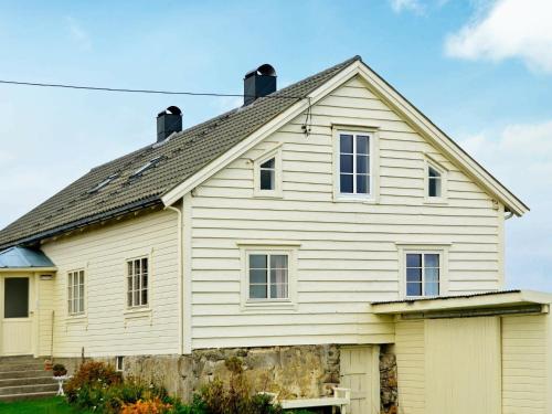a white house with a gray roof at 11 person holiday home in Fj rtoft in Fjørtoft