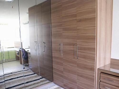 um grande armário de madeira com portas de vidro num escritório em Duplex Apto Setor Hoteleiro Norte com serviço diário de limpeza em Brasília