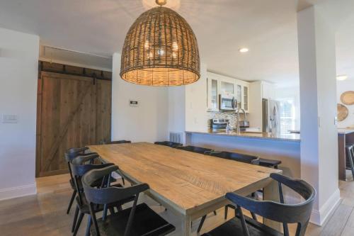 a dining room with a wooden table and chairs at Beachside Cottage in Isle of Palms