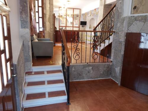 a spiral staircase in a building with a lobby at Hotel Boutique TEKALI INN in Cuetzalán del Progreso