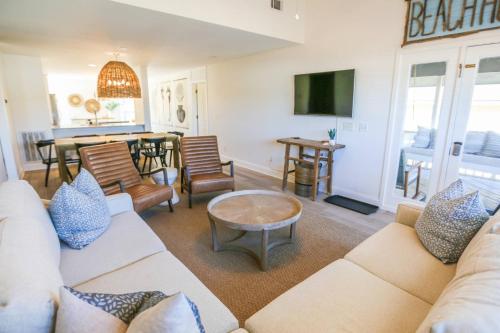 a living room with a couch and a table at Beachside Cottage in Isle of Palms