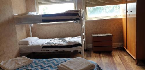 a room with two bunk beds and a window at The Eastern Hotel Accommodation in Ballarat