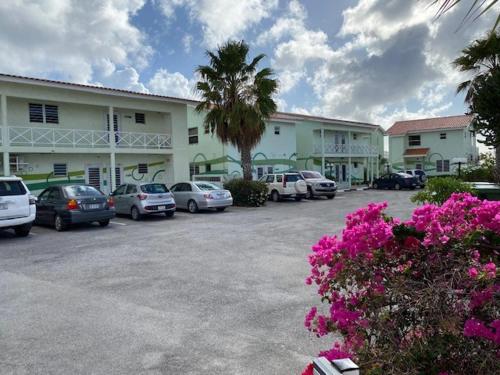 a parking lot with cars parked in front of a building at Blue Lagoon Apartment in Lagun