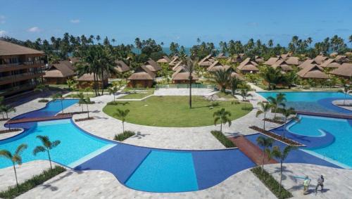 an aerial view of a resort with two pools at Flat 113 Eco Resort Praia dos Carneiros in Praia dos Carneiros