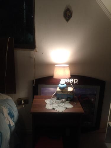 una lámpara en una mesa junto a una TV en Marianela, en Los Ángeles