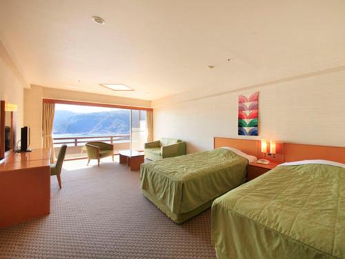 Postel nebo postele na pokoji v ubytování Akazawa Onsen Hotel