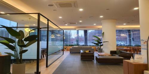 a lobby with couches and chairs in a building at Crown Hotel Changwon in Changwon