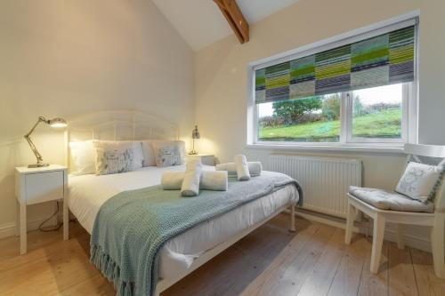 a bedroom with a bed and a window at Westerley in Portreath