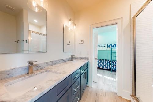 a bathroom with a large sink and a mirror at West Side Cottage #OO in Gulf Shores