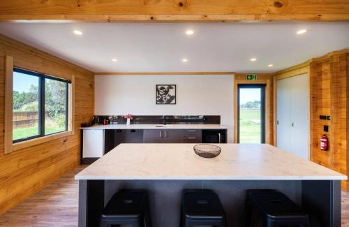 a kitchen with a large island in the middle at Deerbrooke Kaikōura Chalets - Chalet 2 in Kaikoura