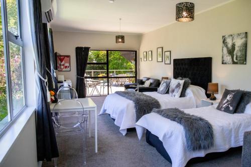 a hotel room with two beds and a window at Swan House in Martinborough