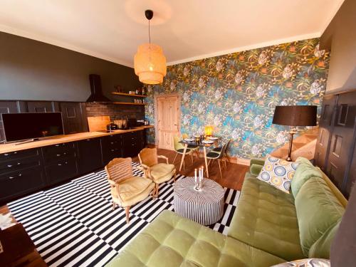 a living room with a couch and a table at Gutshaus Klein kussewitz in Klein Kussewitz
