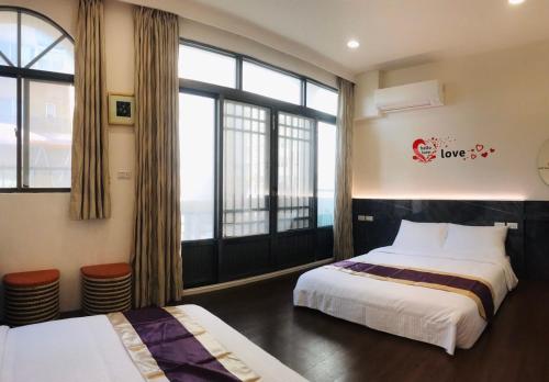 Postel nebo postele na pokoji v ubytování Purple Shell Homestay