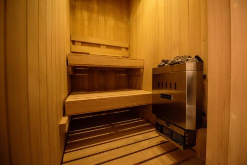 a walkin closet with an empty refrigerator and a box at Hotel Madi in San Miguel de Allende