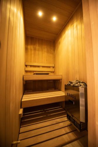 a sauna with wood paneled walls and wooden cabinets at Hotel Madi in San Miguel de Allende