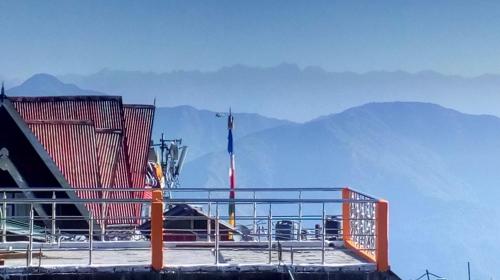 a deck of a ship with mountains in the background at Darjeeling Home in Darjeeling