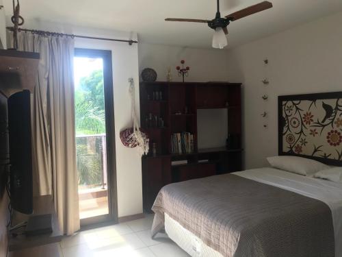 a bedroom with a bed and a sliding glass door at Flat em Resort incrivel a 10 min da Esplanada, STF e PGR in Brasilia
