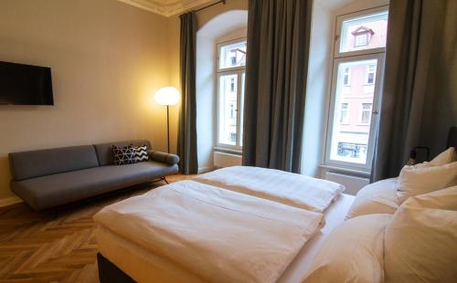 A bed or beds in a room at Le Baldinger Boutique Hotel