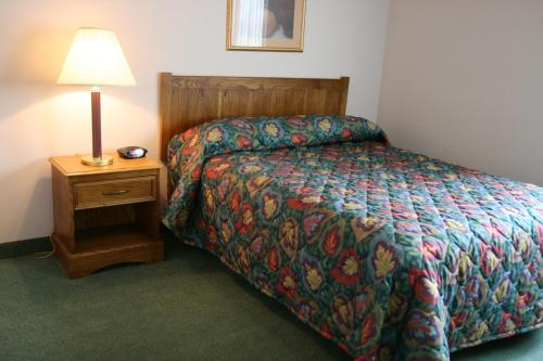 A bed or beds in a room at Affordable Suites Rocky Mount