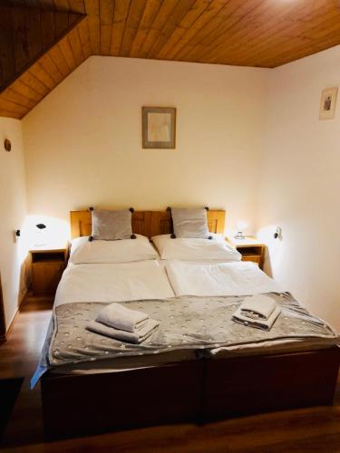 a bedroom with two beds with towels on them at Restaurant a penzion Pod Draci skalou in Karlštejn