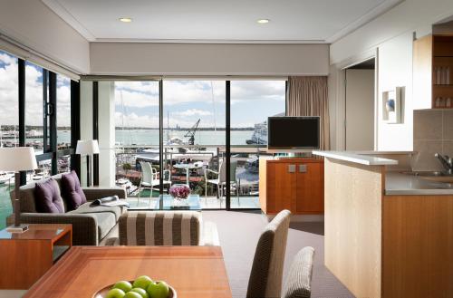 a kitchen filled with furniture and a large window at The Sebel Auckland Viaduct Harbour in Auckland