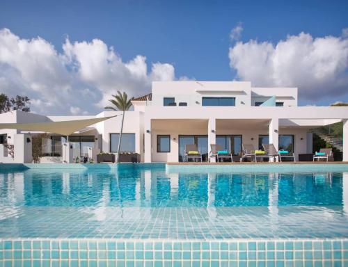 una gran piscina frente a una casa en Extravagante 8 BDRM Villa In Marbella, Beachside, en Marbella