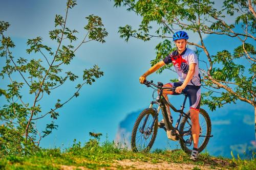 a man riding a bike on a hill at Hotel Le Balze - Aktiv & Wellness in Tremosine Sul Garda