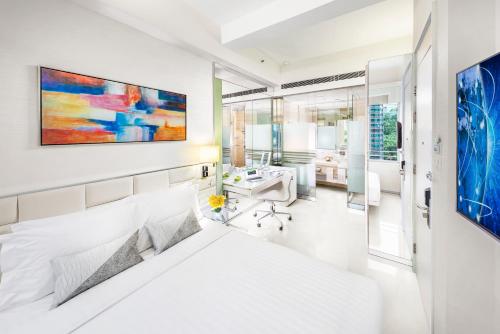 a bedroom with a white bed and a bathroom at iclub Wan Chai Hotel in Hong Kong