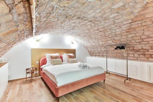 - une chambre avec un lit dans un mur en briques dans l'établissement New&Renovated in heart of PARIS- 6pers, à Paris
