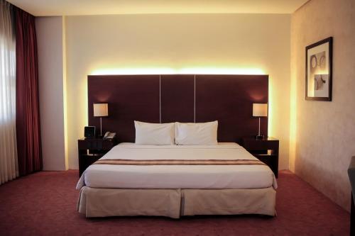 a bedroom with a large bed in a hotel room at Casablanca Suites Near Airport in Legazpi
