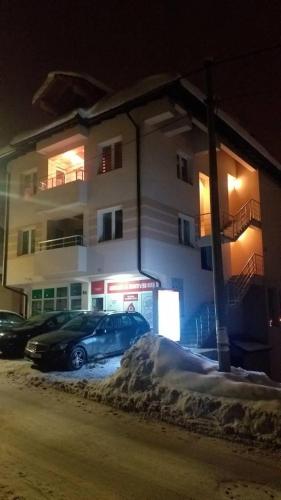 ノヴァ・ヴァロシュにあるApartman Marijaの夜間の建物の前に駐車した車2台
