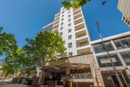 a tall white building on a city street at All Suites Perth in Perth