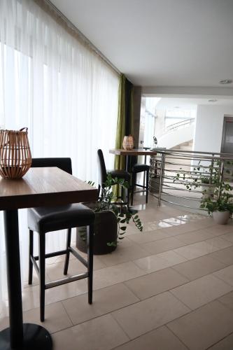 
a living room filled with furniture and a table at Hotel and Park Divoká Voda in Bratislava
