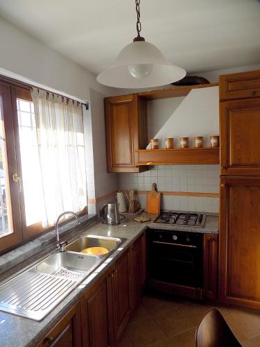 a kitchen with a sink and a stove at Casa Nuccia gentili david in Marina di Massa