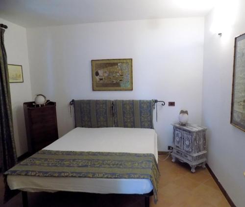 a small bedroom with a bed and a table at Casa Nuccia in Marina di Massa
