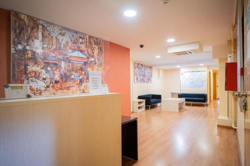 a waiting room with a large painting on the wall at Hostal Fina in Barcelona
