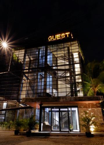 a building with a lit sign on top of it at Guest House 555 NKI in Duku