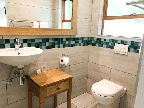 a bathroom with a sink and a toilet at Milner Manor in Grahamstown