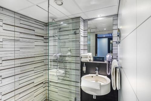 a bathroom with a sink and a shower at Postillion Hotel Deventer in Deventer