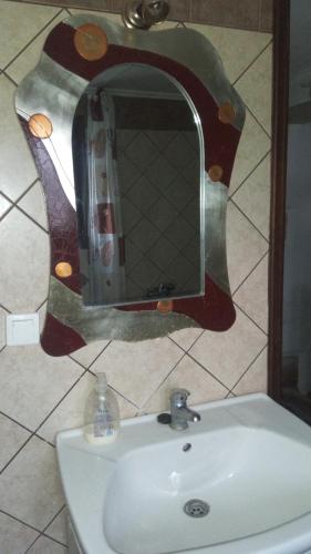 a mirror above a sink in a bathroom at TRADITIONAL HOUSE MARIA in Azoyirás