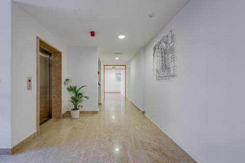 a hallway with white walls and a drawing on the wall at Hotel Pax in Split