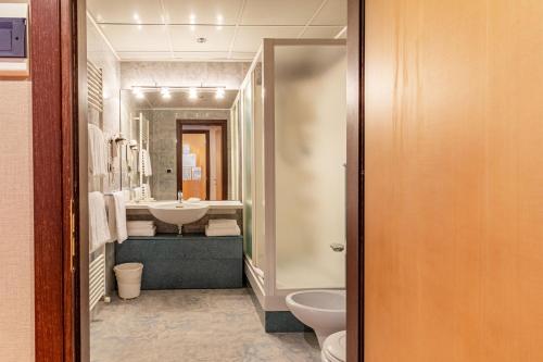 a bathroom with a sink and a toilet at Hotel Ristorante Al Mulino by LVG Hotel Collection in Alessandria