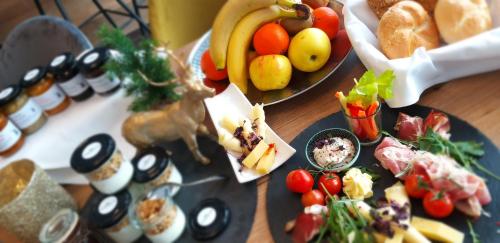 a table with a plate of food with fruits and vegetables at Haidinger's Boutique Domizil in Oftering