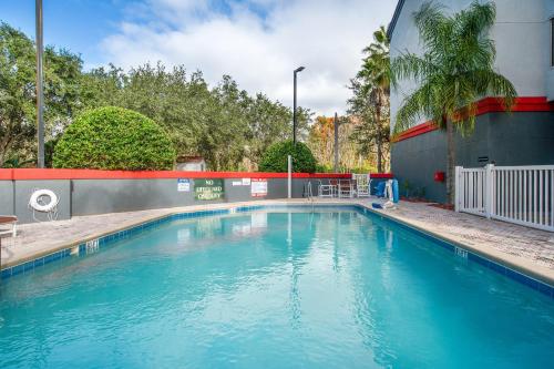 a large blue swimming pool next to a building at Suburban Studios Orlando - Ocoee-Winter Garden in Orlando