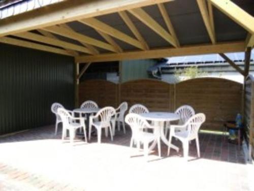 a group of tables and chairs on a patio at Ferienhof Budach in Handewitt