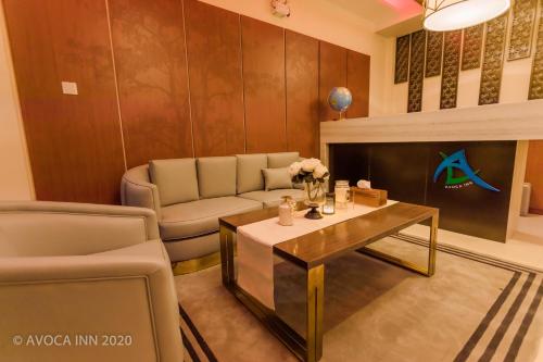 a living room with a couch and a coffee table at Avoca Inn in Hulhumale