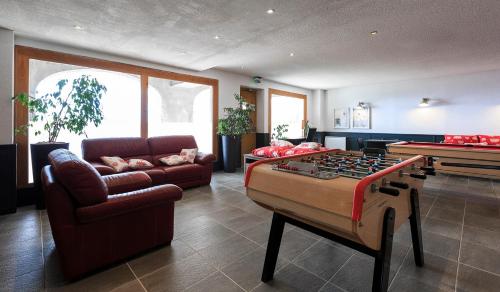 a living room with a pool table and a couch at O - Sancy Résidence de Tourisme in Super Besse